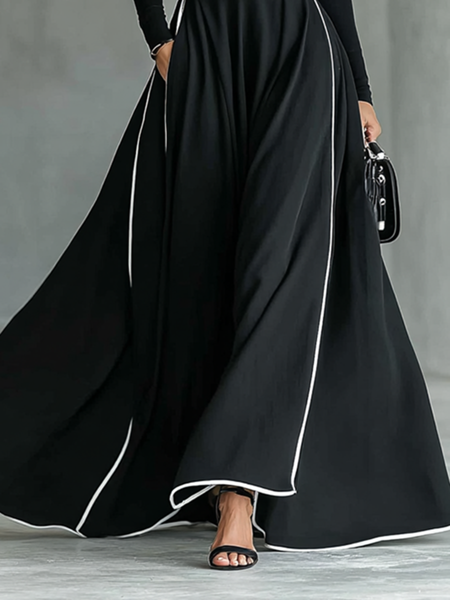 Gina – Vestido Maxi Negro con Costuras Blancas, Cuello Alto y Manga Larga